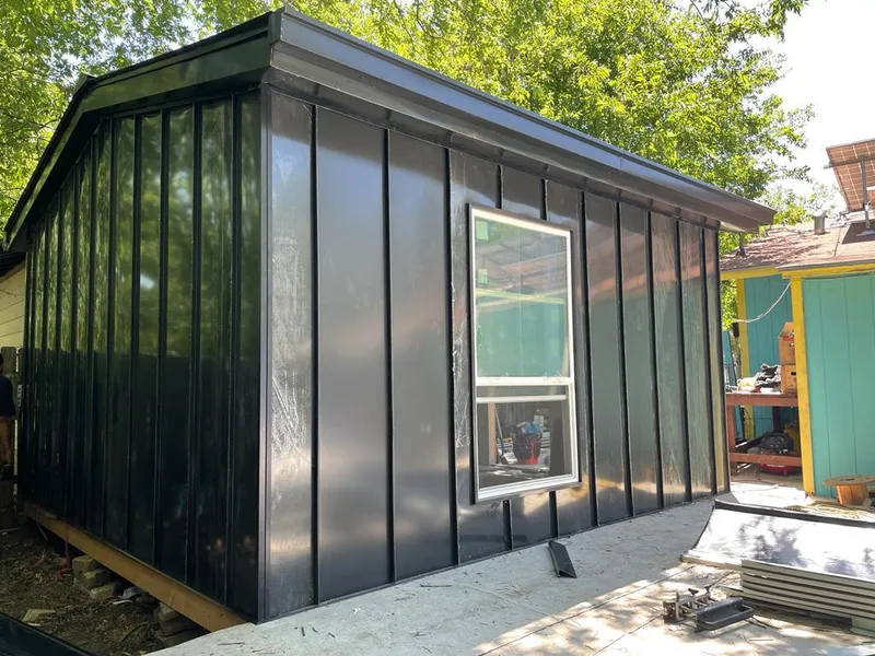 Black standing seam metal wall panels for Roof Inspection in North Tonawanda